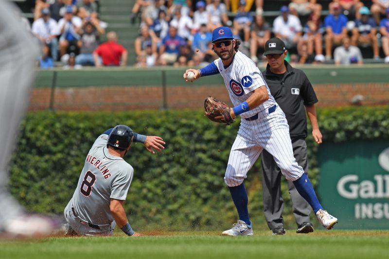 Aug 22, 2024; Chicago, Illinois, USA; Chicago Cubs shortstop Dansby Swanson (7) attempts a double play after forcing out Detroit Tigers center fielder Matt Vierling (8) during the first inning at Wrigley Field. Mandatory Credit: Patrick Gorski-USA TODAY Sports