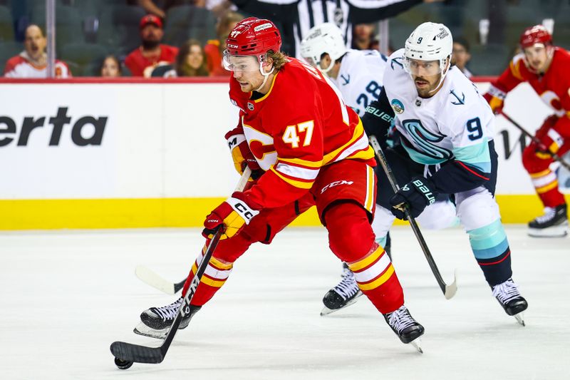 Sep 23, 2025; Calgary, Alberta, CAN; Calgary Flames center Connor Zary (47) skates with the puck against the Seattle Kraken during the second period at Scotiabank Saddledome. Mandatory Credit: Sergei Belski-Imagn Images