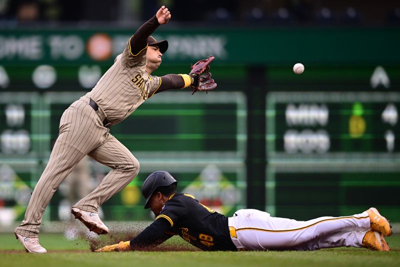 May 3, 2025; Pittsburgh, Pennsylvania, USA; San Diego Padres second baseman Jose Iglesias (7) reaches for the ball as Pittsburgh Pirates first baseman Enmanuel Valdez (48) advances to second base on a pass ball during the third inning at PNC Park. Mandatory Credit: David Dermer-Imagn Images