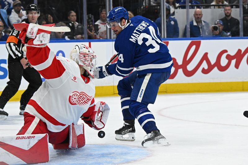 Oct 13, 2025; Toronto, Ontario, CAN; Detroit Red Wings goalie Cameron Talbot (39) makes a save on Toronto Maple Leafs center Auston Matthews (34) in the third period at Scotiabank Arena. Mandatory Credit: Gerry Angus-Imagn Images