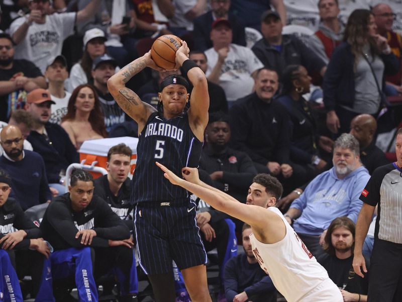 CLEVELAND, OH - APRIL 22:Paolo Banchero #5 of the Orlando Magic looks to pass the ball during the game against the Cleveland Cavaliers  during Round 1 Game 2 of the 2024 NBA Playoffs on April 22, 2024 at Rocket Mortgage FieldHouse in Cleveland, Ohio. NOTE TO USER: User expressly acknowledges and agrees that, by downloading and/or using this Photograph, user is consenting to the terms and conditions of the Getty Images License Agreement. Mandatory Copyright Notice: Copyright 2024 NBAE (Photo by Lauren Leigh Bacho/NBAE via Getty Images)