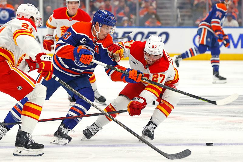 Oct 8, 2025; Edmonton, Alberta, CAN; Edmonton Oilers forward Ryan Nugent-Hopkins (93) tries to carry the puck past Calgary Flames forward Matt Coronato (27) during the first period at Rogers Place. Mandatory Credit: Perry Nelson-Imagn Images