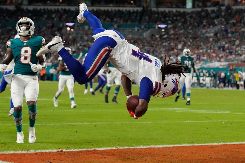 Buffalo Bills running back James Cook (4) goes airborne to score a touchdown during the first half of an NFL football game against the Miami Dolphins, Thursday, Sept. 12, 2024, in Miami Gardens, Fla. (AP Photo/Lynne Sladky)