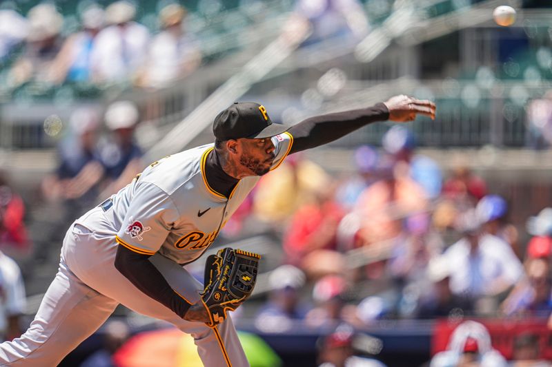 Jun 30, 2024; Cumberland, Georgia, USA; Pittsburgh Pirates relief pitcher Aroldis Chapman (45) pitches against the Atlanta Braves during the ninth inning at Truist Park. Mandatory Credit: Dale Zanine-USA TODAY Sports