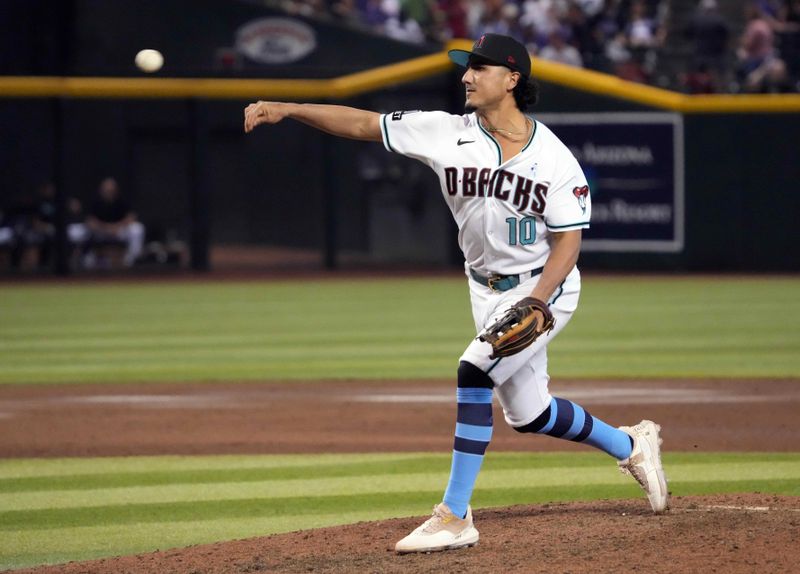 Jun 18, 2023; Phoenix, Arizona, USA; Arizona Diamondbacks relief pitcher Josh Rojas (10) throws against the Cleveland Guardians during the ninth inning at Chase Field. Mandatory Credit: Joe Camporeale-USA TODAY Sports