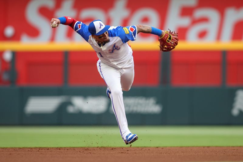 Apr 27, 2024; Atlanta, Georgia, USA; Atlanta Braves shortstop Orlando Arcia (11) attempts to throw a runner out at first against the Cleveland Guardians in the first inning at Truist Park. Mandatory Credit: Brett Davis-USA TODAY Sports