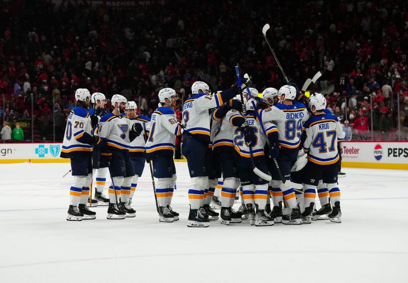 Jan 6, 2024; Raleigh, North Carolina, USA; St. Louis Blues players celebrate their win in the shoot out against the Carolina Hurricanes at PNC Arena. Mandatory Credit: James Guillory-USA TODAY Sports