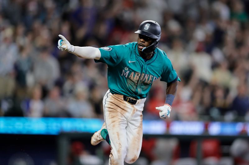 Jun 1, 2024; Seattle, Washington, USA;  Seattle Mariners second baseman Ryan Bliss points as he runs to first after hitting a single against the Los Angeles Angels during the sixth inning at T-Mobile Park. Mandatory Credit: John Froschauer-USA TODAY Sports