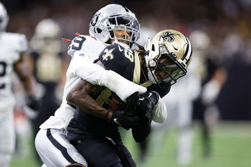 New Orleans Saints wide receiver Rashid Shaheed (89) makes a catch as Las Vegas Raiders cornerback Anthony Averett (29) tackles him during the first half of an NFL football game Sunday, Oct. 30, 2022, in New Orleans. (AP Photo/Rusty Costanza)