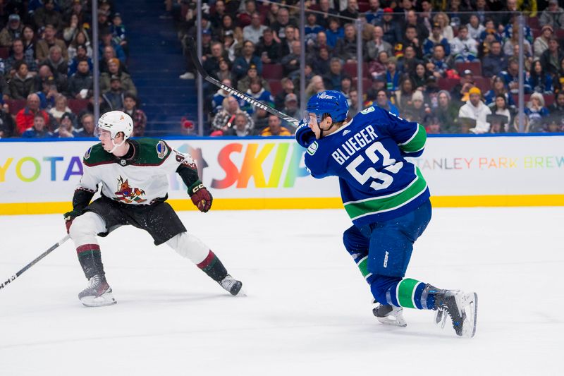 Jan 18, 2024; Vancouver, British Columbia, CAN; Arizona Coyotes forward Logan Cooley (92) watches as Vancouver Canucks forward Teddy Blueger (53) shoots in the third period at Rogers Arena. Vancouver won 2-1. Mandatory Credit: Bob Frid-USA TODAY Sports