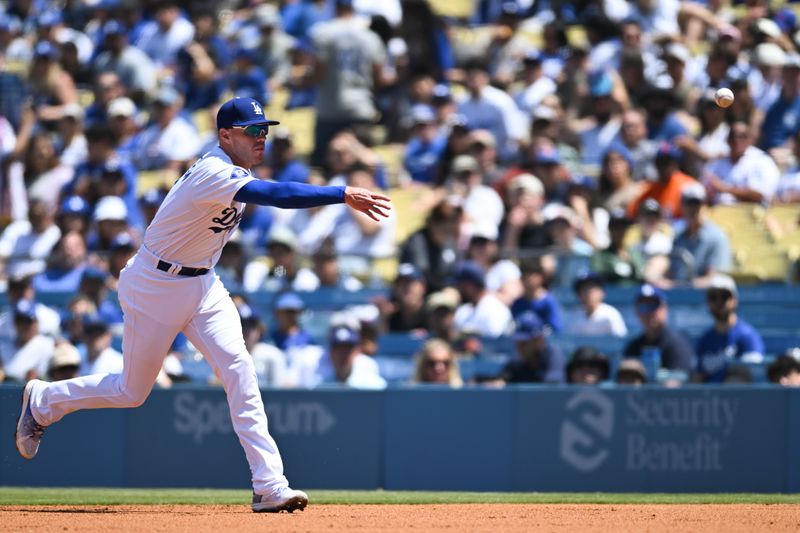 Apr 21, 2024; Los Angeles, California, USA; Los Angeles Dodgers first baseman Freddie Freeman (5) throws to first base for an out against the New York Mets during the second inning at Dodger Stadium. Mandatory Credit: Jonathan Hui-USA TODAY Sports