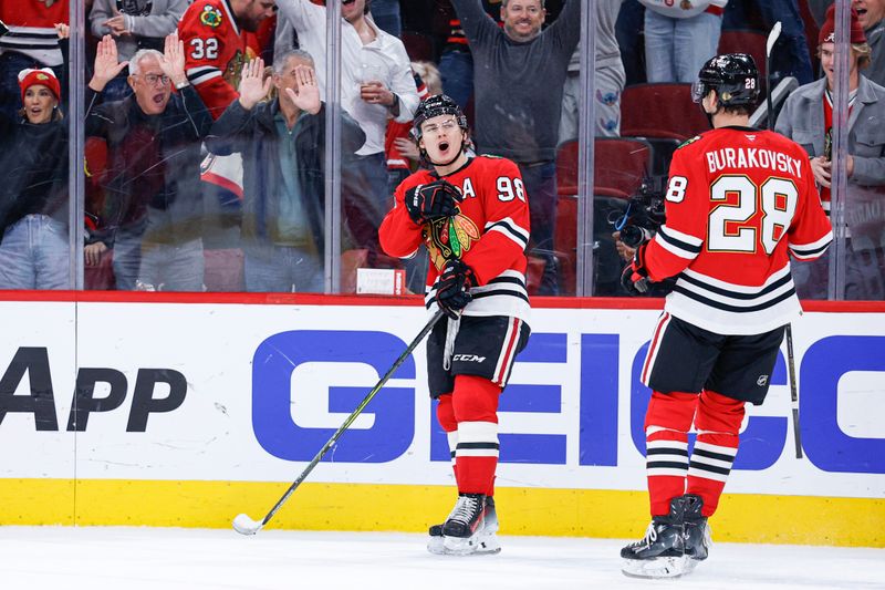 Nov 18, 2025; Chicago, Illinois, USA; Chicago Blackhawks center Connor Bedard (98) celebrates after scoring against the Calgary Flames during the second period at United Center. Mandatory Credit: Kamil Krzaczynski-Imagn Images