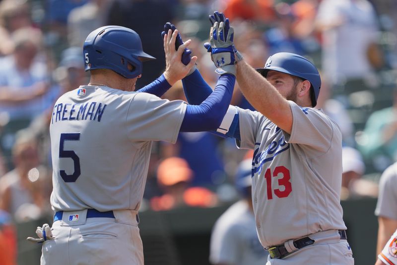 Jul 19, 2023; Baltimore, Maryland, USA; Los Angeles Dodgers third baseman Max Muncy (13) greeted by first baseman Freddie Freeman (5) following his two run home run in the fifth inning against the Baltimore Orioles at Oriole Park at Camden Yards. Mandatory Credit: Mitch Stringer-USA TODAY Sports