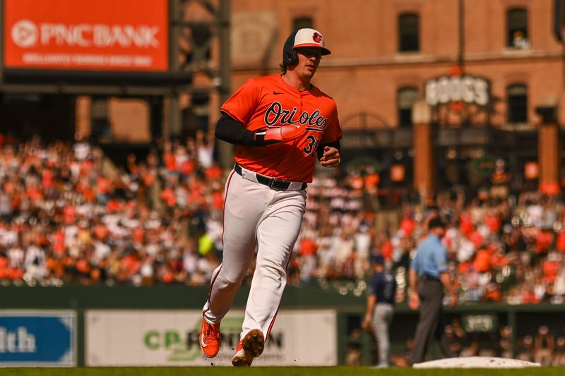 Jun 1, 2024; Baltimore, Maryland, USA; Baltimore Orioles catcher Adley Rutschman (35) rounds the baes on  first baseman Ryan Mountcastle (6) first inning home run against the Tampa Bay Rays  at Oriole Park at Camden Yards. Mandatory Credit: Tommy Gilligan-USA TODAY Sports