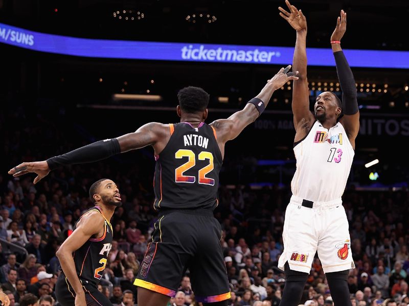 PHOENIX, ARIZONA - JANUARY 06: Bam Adebayo #13 of the Miami Heat puts up a shot over Deandre Ayton #22 of the Phoenix Suns during the first half of the NBA game at Footprint Center on January 06, 2023 in Phoenix, Arizona. NOTE TO USER: User expressly acknowledges and agrees that, by downloading and or using this photograph, User is consenting to the terms and conditions of the Getty Images License Agreement. (Photo by Christian Petersen/Getty Images)