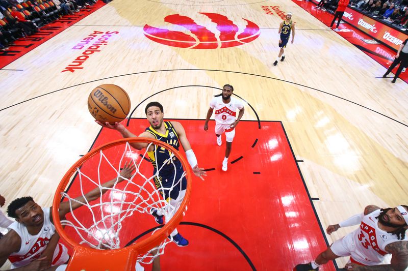 TORONTO, CANADA - APRIL 9:  Tyrese Haliburton #0 of the Indiana Pacers goes to the basket during the game on April 9, 2024 at the Scotiabank Arena in Toronto, Ontario, Canada.  NOTE TO USER: User expressly acknowledges and agrees that, by downloading and or using this Photograph, user is consenting to the terms and conditions of the Getty Images License Agreement.  Mandatory Copyright Notice: Copyright 2024 NBAE (Photo by Vaughn Ridley/NBAE via Getty Images)