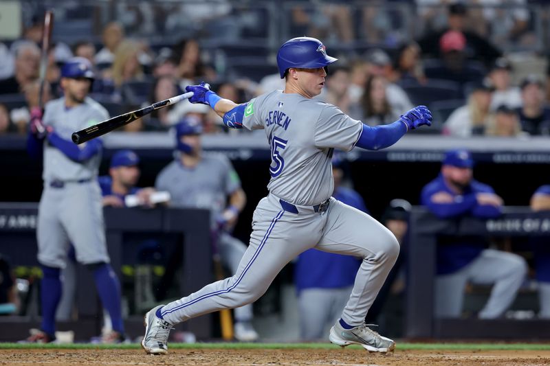 Aug 2, 2024; Bronx, New York, USA; Toronto Blue Jays catcher Brian Serven (15) follows through on an RBI single against the New York Yankees during the third inning at Yankee Stadium. Mandatory Credit: Brad Penner-USA TODAY Sports