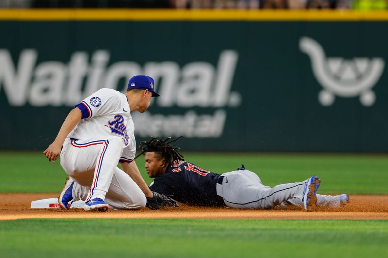 May 13, 2024; Arlington, Texas, USA; Cleveland Guardians third base José Ramírez (11) slides in under the tag of Texas Rangers shortstop Corey Seager (5) during the first inning at Globe Life Field. Mandatory Credit: Andrew Dieb-USA TODAY Sports