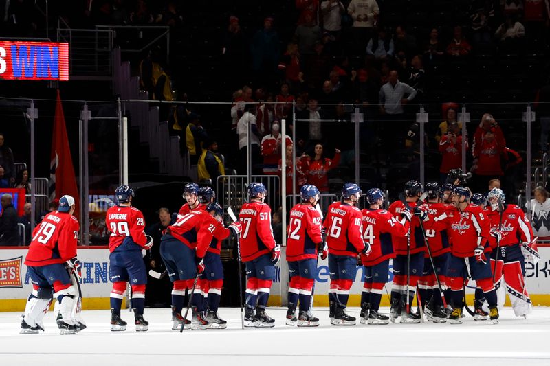 Oct 15, 2024; Washington, District of Columbia, USA; Washington Capitals players celebrate after their game against the Vegas Golden Knights at Capital One Arena. Mandatory Credit: Geoff Burke-Imagn Images