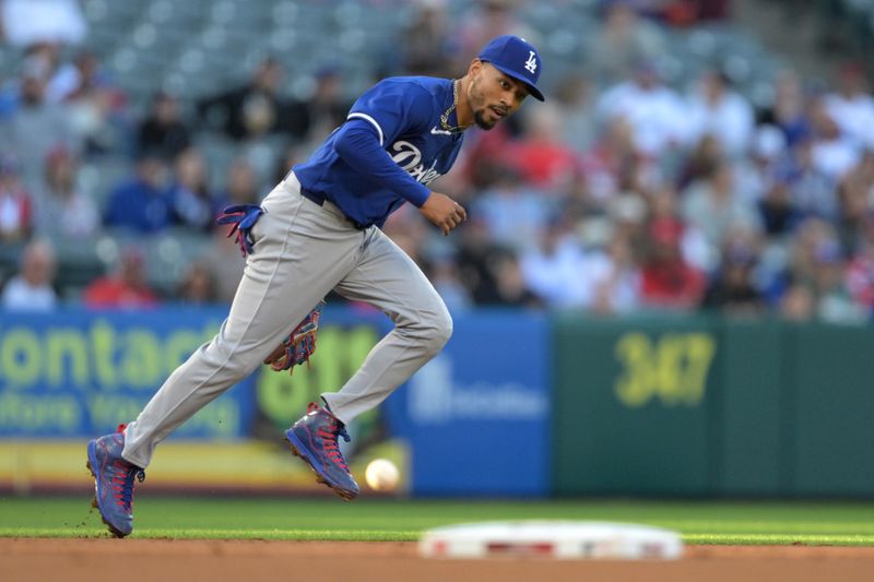 Mar 26, 2024; Anaheim, California, USA;  Los Angeles Angels center fielder Aaron Hicks (12) hits a RBI double past Los Angeles Dodgers shortstop Mookie Betts (50) in the first inning at Angel Stadium. Mandatory Credit: Jayne Kamin-Oncea-USA TODAY Sports