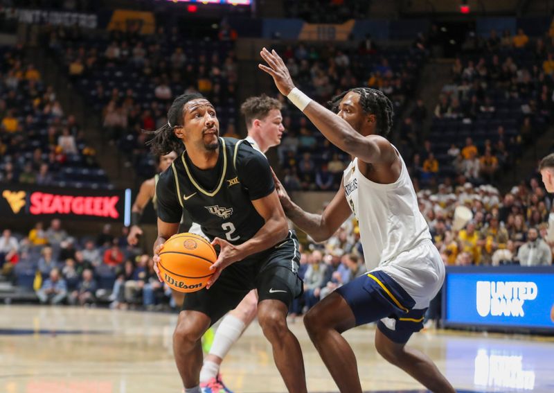 Feb 20, 2024; Morgantown, West Virginia, USA; UCF Knights guard Shemarri Allen (2) shoots against West Virginia Mountaineers guard Kobe Johnson (2) during the first half at WVU Coliseum. Mandatory Credit: Ben Queen-USA TODAY Sports