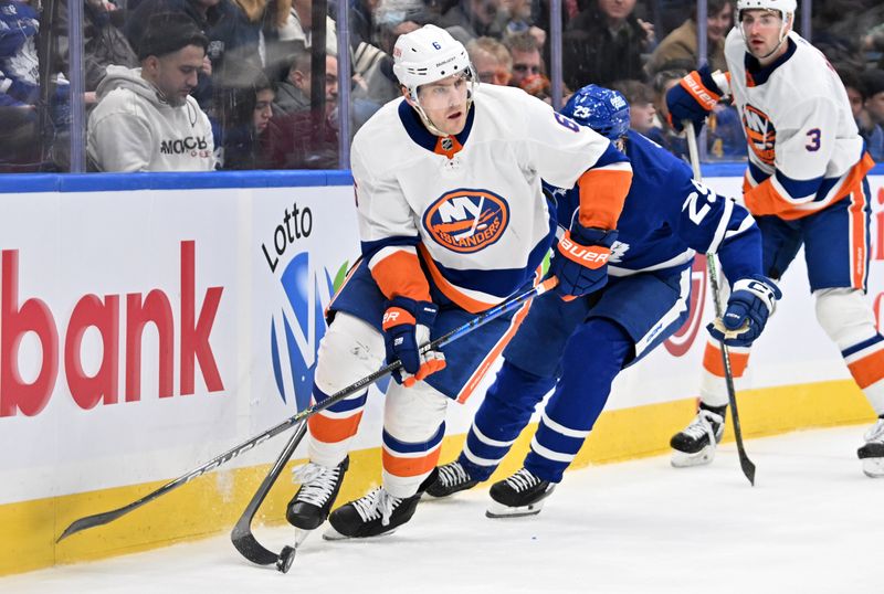 Feb 5, 2024; Toronto, Ontario, CAN;   New York Islanders defenseman Ryan Pulock (6) moves the puck as Toronto Maple Leafs forward Pontus Holmberg (29) gives pursuit in the third period at Scotiabank Arena. Mandatory Credit: Dan Hamilton-USA TODAY Sports