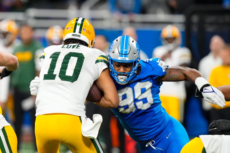 Detroit Lions defensive end Za'Darius Smith (99) sacks Green Bay Packers quarterback Jordan Love (10) during the first half of an NFL football game in Detroit, Thursday, Dec. 5, 2024. (AP Photo/Carlos Osorio)