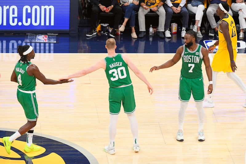 INDIANAPOLIS, IN - MAY 27: Jrue Holiday #4 of the Boston Celtics Sam Hauser #30 of the Boston Celtics and Jaylen Brown #7 of the Boston Celtics high five during the game  against the Indiana Pacers  during Game 4 of the Eastern Conference Finals of the 2024 NBA Playoffs on May 27, 2024 at Gainbridge Fieldhouse in Indianapolis, Indiana. NOTE TO USER: User expressly acknowledges and agrees that, by downloading and or using this Photograph, user is consenting to the terms and conditions of the Getty Images License Agreement. Mandatory Copyright Notice: Copyright 2024 NBAE (Photo by Brian Babineau/NBAE via Getty Images)