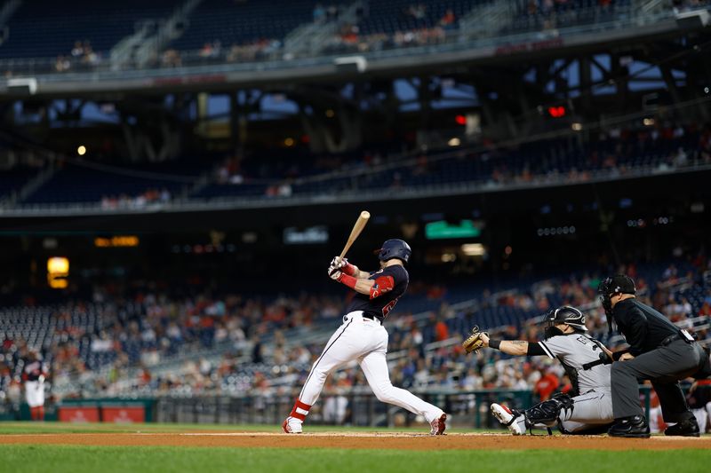 Sep 18, 2023; Washington, District of Columbia, USA; Washington Nationals right fielder Lane Thomas (28) singles against the Chicago White Sox during the first inning at Nationals Park. Mandatory Credit: Geoff Burke-USA TODAY Sports