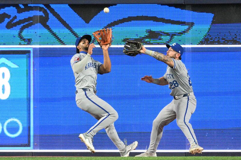 Apr 29, 2024; Toronto, Ontario, CAN; Kansas City Royals left fielder MJ Melendez (1) and center Kyle Isbel (28) reach for a fly ball hit by Toronto Blue Jays shortstop Isiah Kiner-Falefa (not shown) in the seventh inning at Rogers Centre. Mandatory Credit: Dan Hamilton-USA TODAY Sports