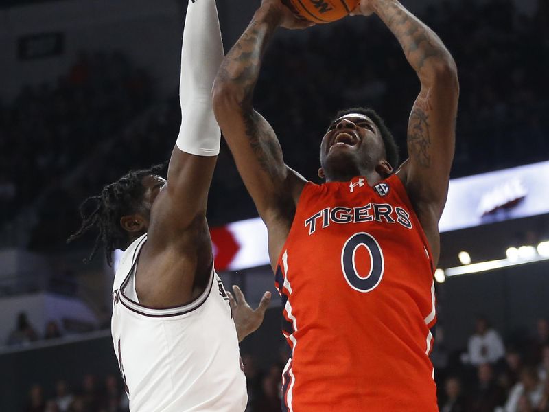 Jan 27, 2024; Starkville, Mississippi, USA; Auburn Tigers guard K.D. Johnson (0) shoots as Mississippi State Bulldogs forward Cameron Matthews (4) defends during the first half at Humphrey Coliseum. Mandatory Credit: Petre Thomas-USA TODAY Sports