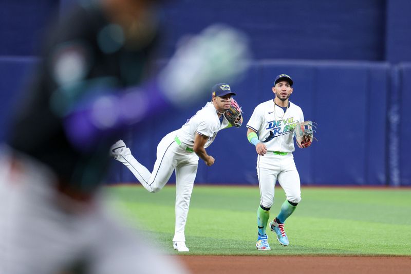 Aug 16, 2024; St. Petersburg, Florida, USA; Tampa Bay Rays second baseman Christopher Morel (24) throws out Arizona Diamondbacks outfielder Lourdes Gurriel Jr. (12) at home plate in the fourth inning at Tropicana Field. Mandatory Credit: Nathan Ray Seebeck-USA TODAY Sports