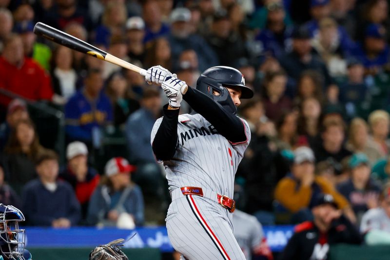 May 31, 2025; Seattle, Washington, USA; Minnesota Twins designated hitter Trevor Larnach (9) hits an RBI-single against the Seattle Mariners during the ninth inning at T-Mobile Park. Mandatory Credit: Joe Nicholson-Imagn Images