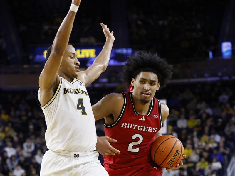 Feb 27, 2025; Ann Arbor, Michigan, USA;  Rutgers Scarlet Knights guard Dylan Harper (2) dribbles defended by Michigan Wolverines guard Nimari Burnett (4) in the second half at Crisler Center. Mandatory Credit: Rick Osentoski-Imagn Images