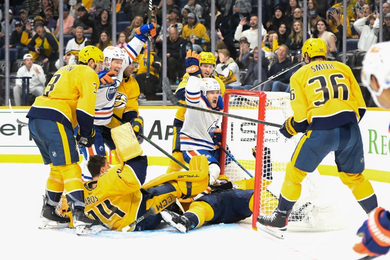 Oct 17, 2024; Nashville, Tennessee, USA;  Edmonton Oilers center Jeff Skinner (53) scores past Nashville Predators goaltender Juuse Saros (74) as left wing Viktor Arvidsson (33) celebrates during the second period at Bridgestone Arena. Mandatory Credit: Steve Roberts-Imagn Images