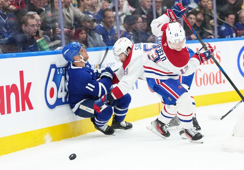 Nov 9, 2024; Toronto, Ontario, CAN; Montreal Canadiens defenseman David Savard (58) battles along the boards with Toronto Maple Leafs center Max Domi (11) during the first period at Scotiabank Arena. Mandatory Credit: Nick Turchiaro-Imagn Images