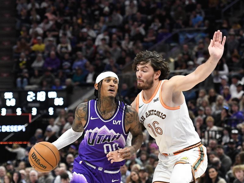 SALT LAKE CITY, UTAH - FEBRUARY 25: Jordan Clarkson #00 of the Utah Jazz drives against Cedi Osman #16 of the San Antonio Spurs during the second half at Delta Center on February 25, 2024 in Salt Lake City, Utah. NOTE TO USER: User expressly acknowledges and agrees that, by downloading and or using this photograph, User is consenting to the terms and conditions of the Getty Images License Agreement. (Photo by Alex Goodlett/Getty Images)