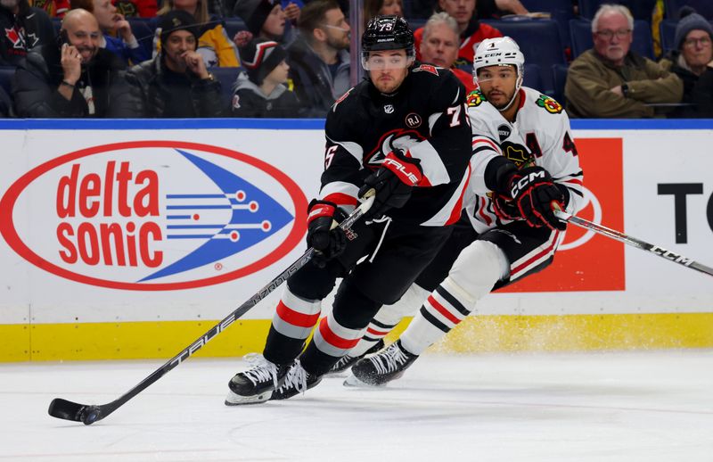 Jan 18, 2024; Buffalo, New York, USA;  Buffalo Sabres defenseman Connor Clifton (75) looks to pass as Chicago Blackhawks defenseman Seth Jones (4) defends during the third period at KeyBank Center. Mandatory Credit: Timothy T. Ludwig-USA TODAY Sports