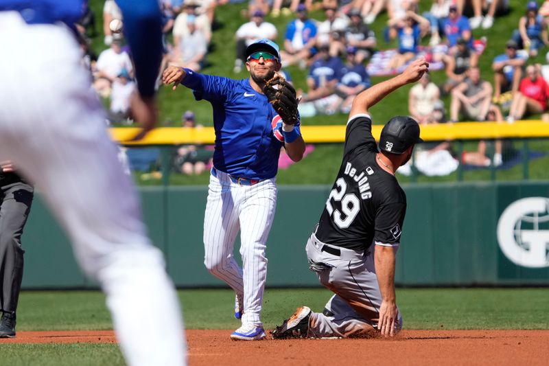 Mar 1, 2024; Mesa, Arizona, USA; Chicago Cubs third baseman Nick Madrigal (1) gets during the first inning at Sloan Park. Mandatory Credit: Rick Scuteri-USA TODAY Sports the force out on Chicago White Sox shortstop Paul DeJong 