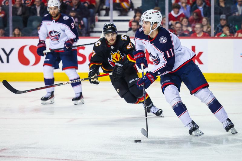 Jan 25, 2024; Calgary, Alberta, CAN; Columbus Blue Jackets center Adam Fantilli (11) controls the puck against the Calgary Flames during the third period at Scotiabank Saddledome. Mandatory Credit: Sergei Belski-USA TODAY Sports