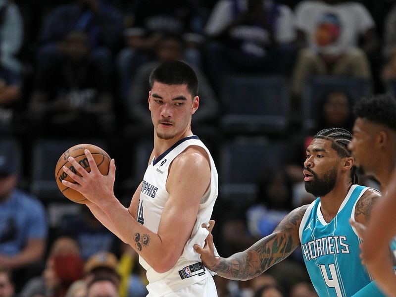MEMPHIS, TENNESSEE - OCTOBER 10: Zach Edey #14 of the Memphis Grizzlies handles the ball against Charlie Brown Jr. #4 of the Charlotte Hornets during the first half at FedExForum on October 10, 2024 in Memphis, Tennessee. NOTE TO USER: User expressly acknowledges and agrees that, by downloading and or using this photograph, User is consenting to the terms and conditions of the Getty Images License Agreement. (Photo by Justin Ford/Getty Images)