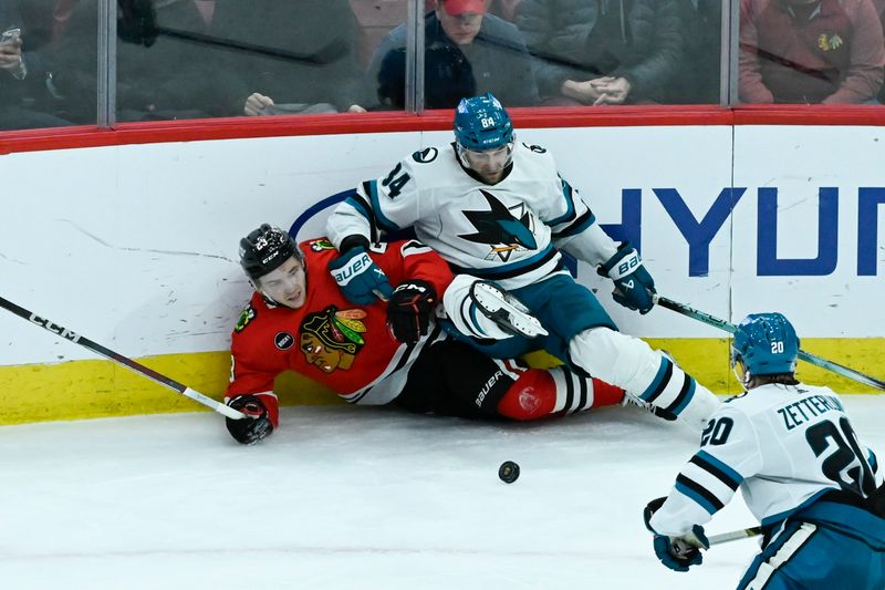 Jan 16, 2024; Chicago, Illinois, USA; Chicago Blackhawks center Philipp Kurashev (23) and San Jose Sharks defenseman Jan Rutta (84) chase the puck during the second period at United Center. Mandatory Credit: Matt Marton-USA TODAY Sports