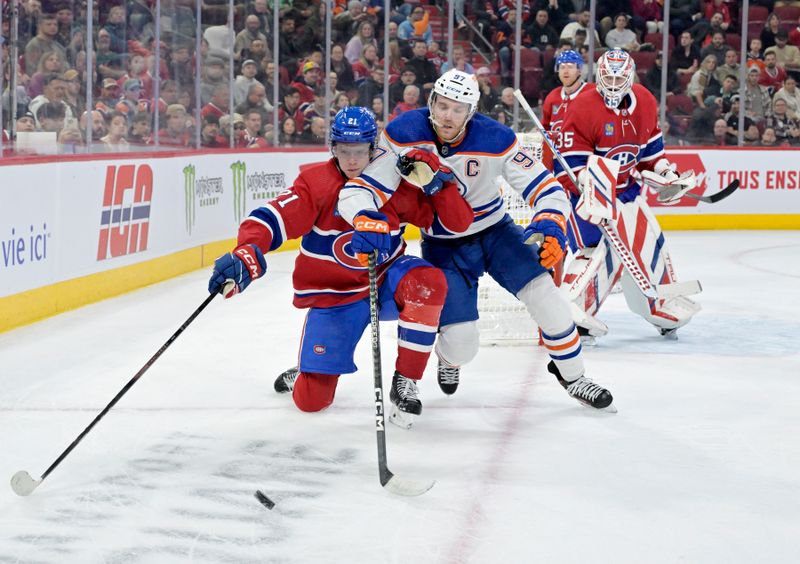 Jan 13, 2024; Montreal, Quebec, CAN; Montreal Canadiens defenseman Kaiden Guhle (21) and Edmonton Oilers forward Connor McDavid (97) battle for the puck during the first period at the Bell Centre. Mandatory Credit: Eric Bolte-USA TODAY Sports