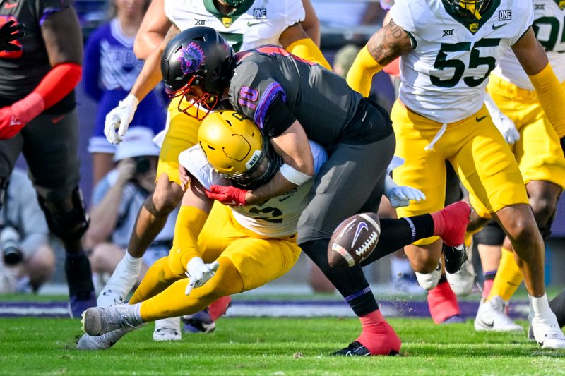 Nov 18, 2023; Fort Worth, Texas, USA; Baylor Bears linebacker Matt Jones (2) and TCU Horned Frogs quarterback Josh Hoover (10) battle for control of a fumble during the first half at Amon G. Carter Stadium. Mandatory Credit: Jerome Miron-USA TODAY Sports