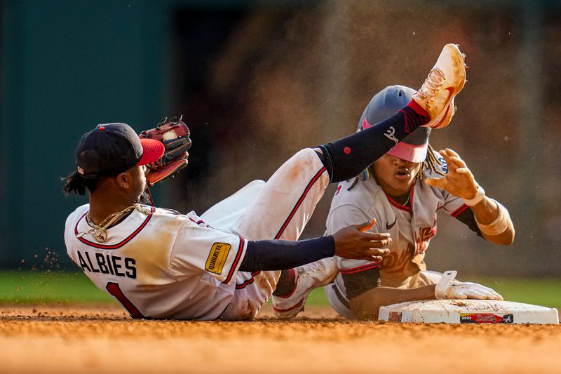 Oct 1, 2023; Cumberland, Georgia, USA; Washington Nationals shortstop CJ Abrams (5) collides with Atlanta Braves second baseman Ozzie Albies (1) after stealing second base during the eighth inning at Truist Park. Mandatory Credit: Dale Zanine-USA TODAY Sports