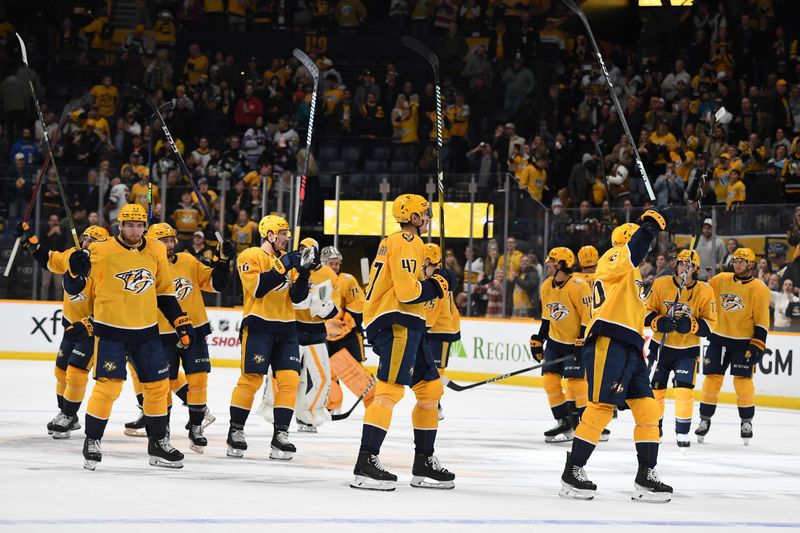 Nov 28, 2023; Nashville, Tennessee, USA; Nashville Predators players celebrate after an overtime win against the Pittsburgh Penguins at Bridgestone Arena. Mandatory Credit: Christopher Hanewinckel-USA TODAY Sports