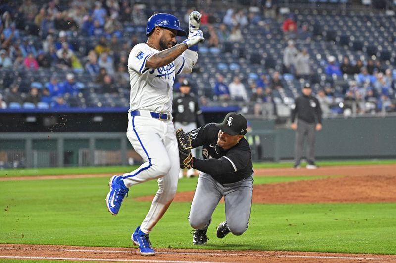 May 7, 2025; Kansas City, Missouri, USA;  Chicago White Sox first baseman Miguel Vargas (20) tags out Kansas City Royals third baseman Maikel Garcia (11) running down the first baseline in the seventh inning at Kauffman Stadium. Mandatory Credit: Peter Aiken-Imagn Images