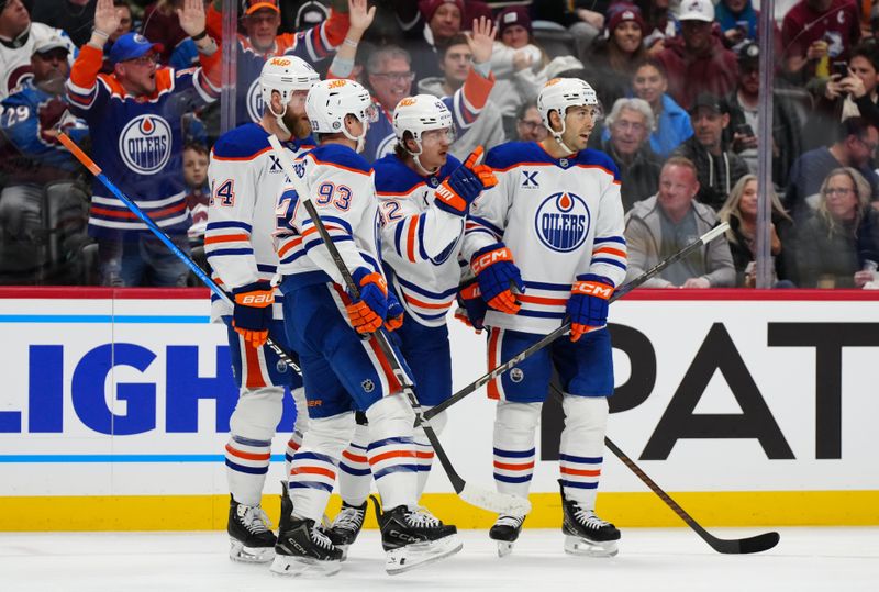 Nov 30, 2024; Denver, Colorado, USA; Edmonton Oilers right wing Kasperi Kapanen (42) celebrates his goal with defenseman Evan Bouchard (2) and defenseman Mattias Ekholm (14) and center Ryan Nugent-Hopkins (93) in the first period against the Colorado Avalanche at Ball Arena. Mandatory Credit: Ron Chenoy-Imagn Images