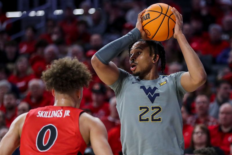 Mar 9, 2024; Cincinnati, Ohio, USA; West Virginia Mountaineers forward Josiah Harris (22) holds the ball against Cincinnati Bearcats guard Dan Skillings Jr. (0) in the second half at Fifth Third Arena. Mandatory Credit: Katie Stratman-USA TODAY Sports