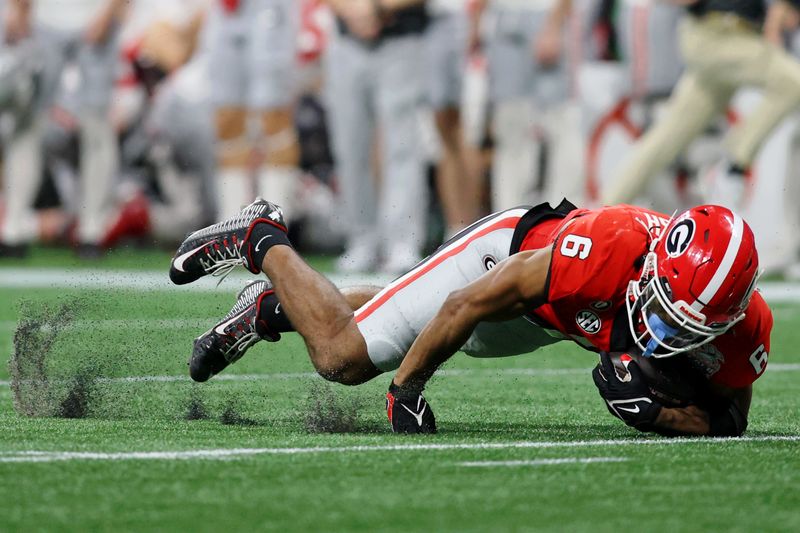 Dec 31, 2022; Atlanta, Georgia, USA; Georgia Bulldogs running back Kenny McIntosh (6) stumbles on the turf and falls while running with the ball against the Ohio State Buckeyes during the first half of the 2022 Peach Bowl at Mercedes-Benz Stadium. Mandatory Credit: Brett Davis-USA TODAY Sports